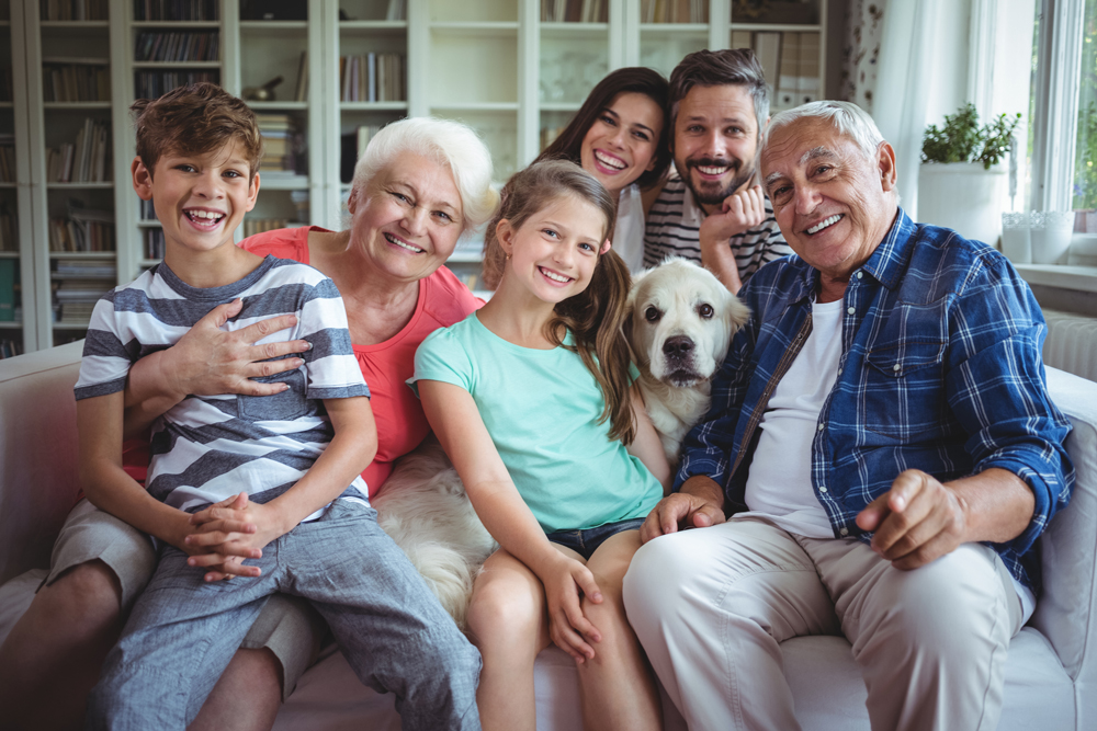 portrait-happy-family-sitting-sofa-living-room